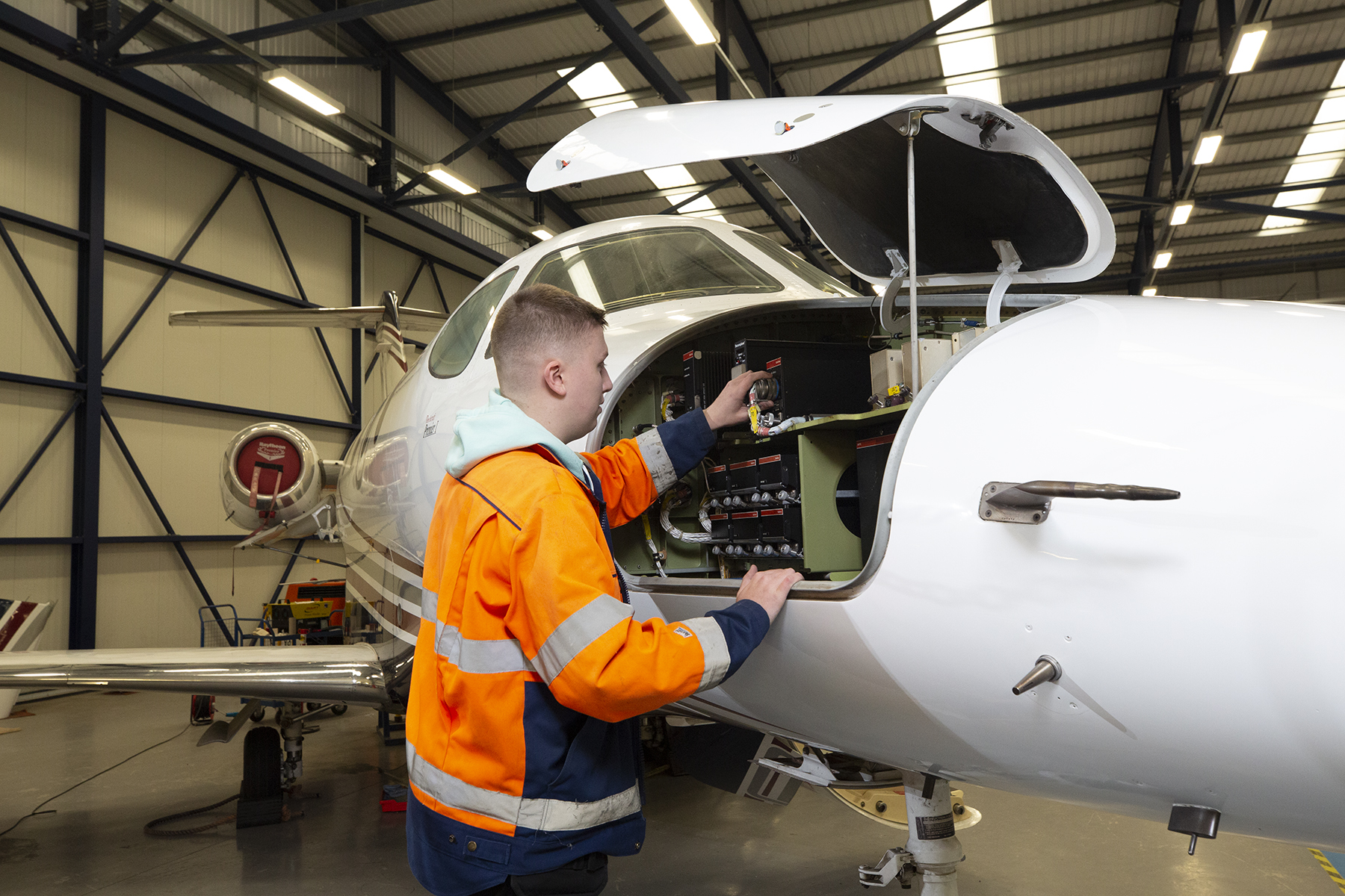 Student Working On Side Panel Of Plane Landscape