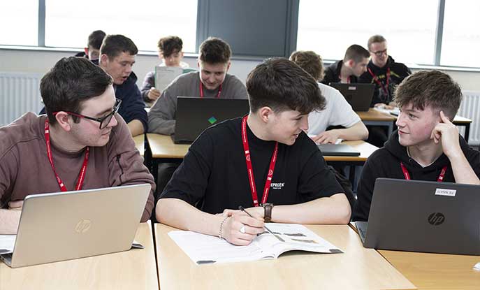 FE Aviation Students In Academy Classroom On Laptops Large Group
