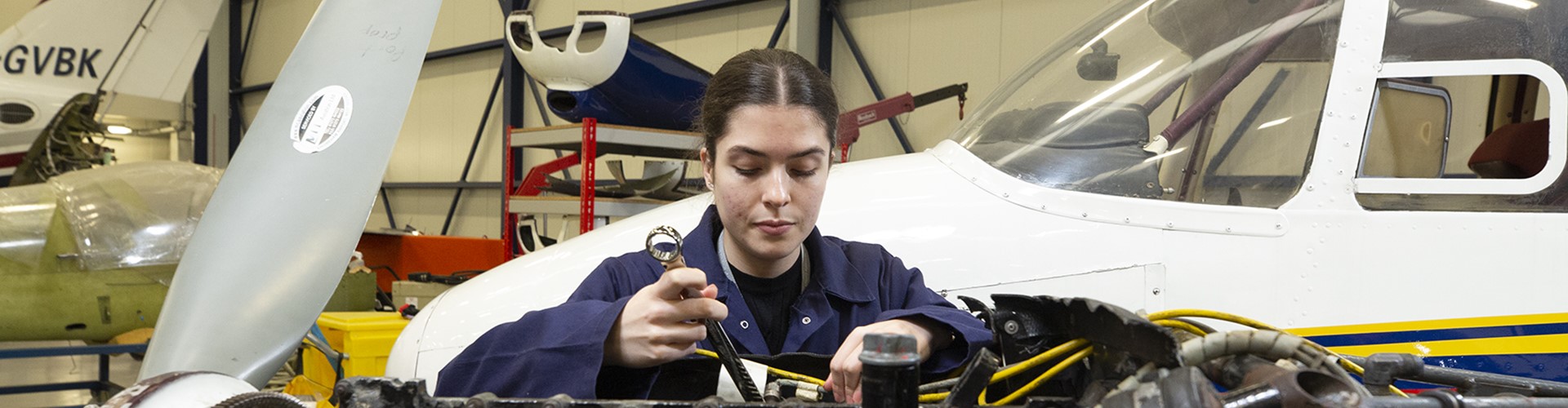 Student Working On Engine Wide Background